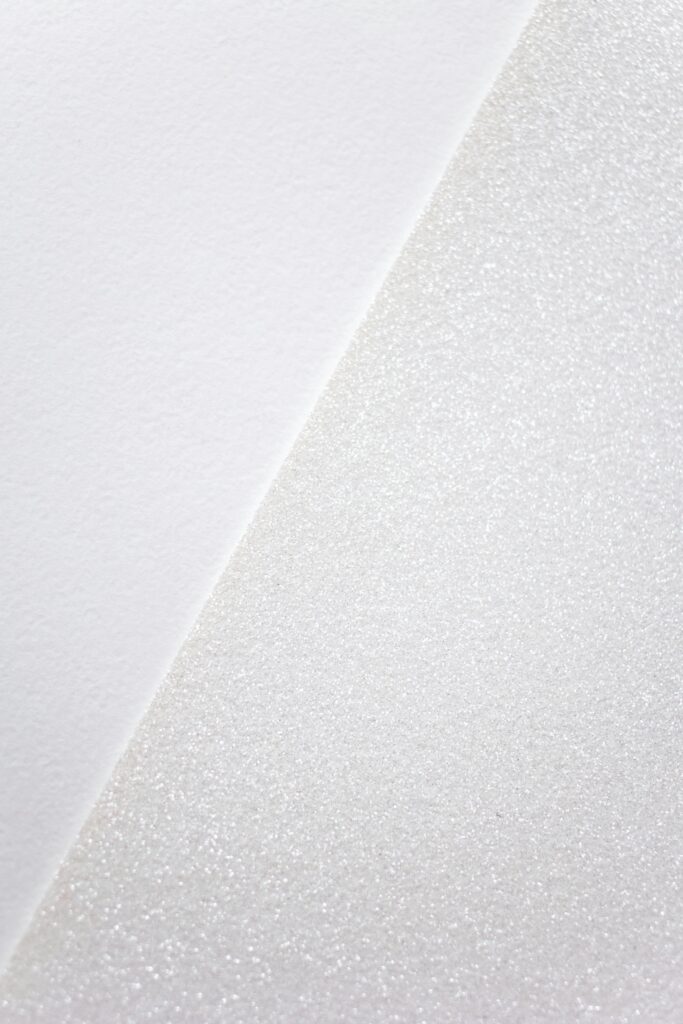 Close-up of minimalist white textured surface, offering a simple and serene visual.