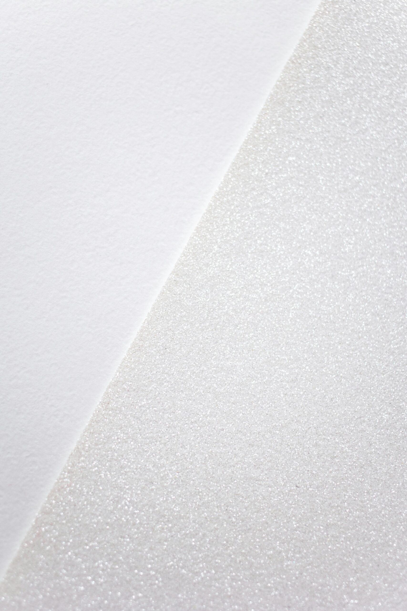 Close-up of minimalist white textured surface, offering a simple and serene visual.